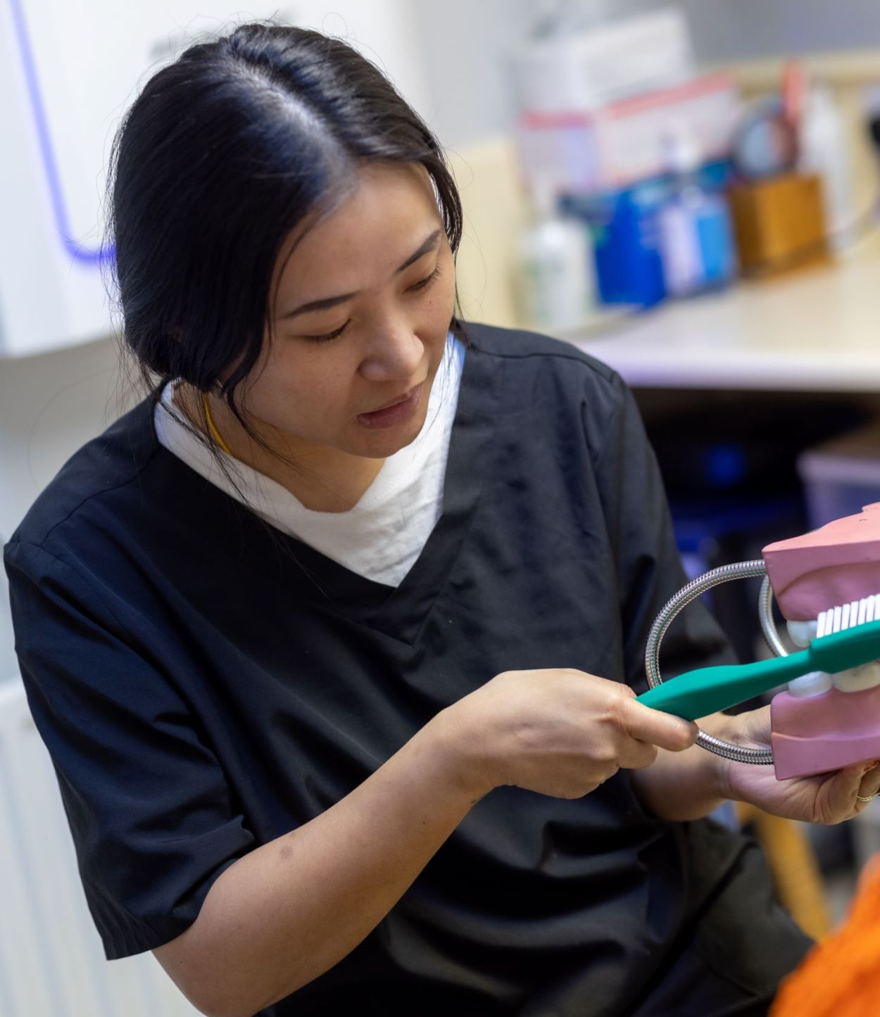 Hygienist showing a patient how to brush at Guildford Dental Centre
